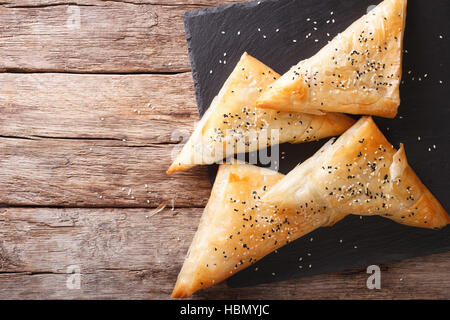 Deliziose torte filo sfoglia con pollo, spinaci e feta vicino sul tavolo. Vista orizzontale dal di sopra Foto Stock