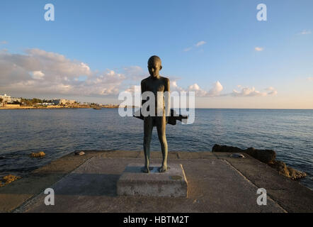 Il piccolo Pescatore"- una scultura in bronzo di un giovane ragazzo e un grande pesce, da Paphos artista, Giota Ioannidou. Foto Stock