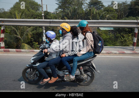 Familiy di quattro sul sovraccarico scooter, Città di Ho Chi Minh (Saigon), Vietnam Foto Stock