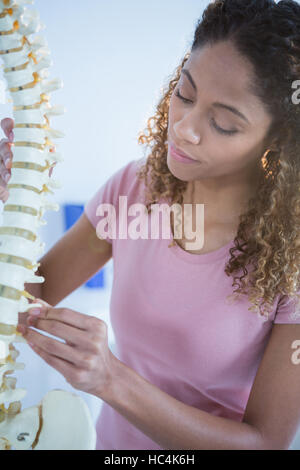 Donna che mantiene il modello della colonna vertebrale Foto Stock