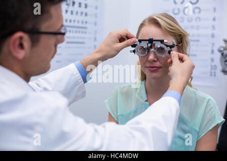 All'ottico optometrista esame paziente femmina con phoropter Foto Stock