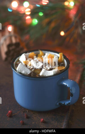 Cioccolata calda con arancia e marshmallows sullo sfondo marrone in verticale Foto Stock