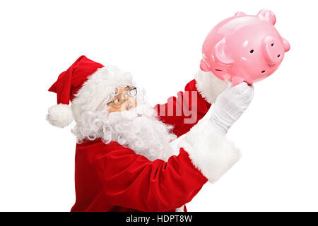 Babbo Natale lo scuotimento di un piggybank isolati su sfondo bianco Foto Stock