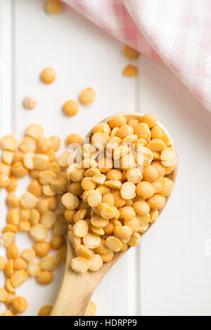 Giallo piselli spezzati nella ciotola di legno sul tavolo da cucina. Vista dall'alto. Foto Stock