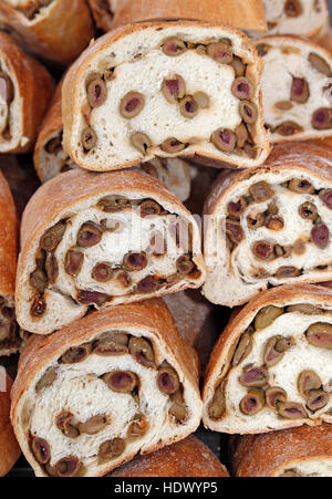 Le pagnotte di pane con le olive mature per la vendita nello stand del mercato italiano Foto Stock