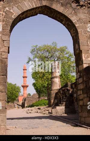 Vittoria islamica torre (Chand Minar) incorniciato in ingresso al forte di Daulatabad, India. Il XIV secolo D.C. Foto Stock