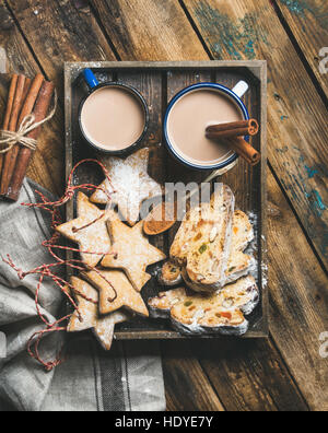 Cacao in tazze con biscotti di Natale, pezzi di torta Stollen Foto Stock