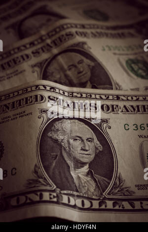 Vecchio e accartocciata negli Stati Uniti un dollaro banconote fotografato con messa a fuoco poco profonda e un antico filtro applicato all'immagine Foto Stock