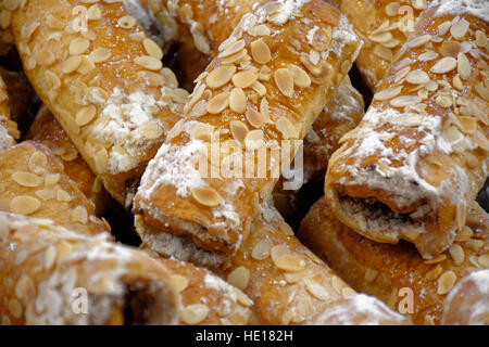 Dolci di forma realizzato i cannoli di pasta fritta con un ripieno di ricotta con cioccolato e ricoperto con pasta di mandorle. Foto Stock