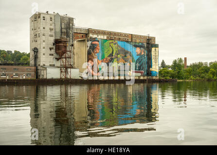Elevatori della granella con pittura colorata si riflette nelle acque del porto Foto Stock