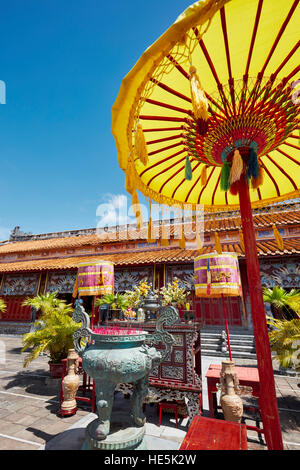 Altare di bronzo incenso urn e ombrellone giallo al Mieu al tempio. Città Imperiale (Cittadella), tonalità, Vietnam. Foto Stock