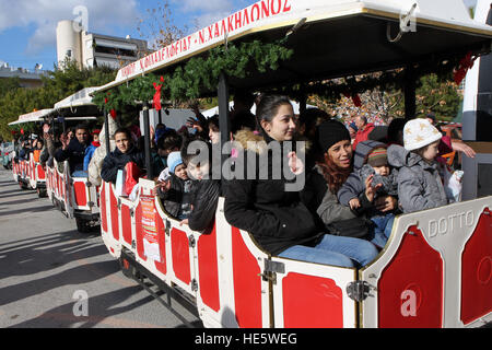 Atene, Grecia. Xvii Dec, 2016. La gente ride un treno di Natale durante un evento per i bambini rifugiati a Atene, Grecia, a Dic. 17, 2016. Circa 65 bambini profughi ospitati presso un hotel di Atene hanno dato un tour qui il sabato presso il villaggio di Natale, istituito dal comune di Nea Filadelfia prima delle vacanze. © Marios Lolos/Xinhua/Alamy Live News Foto Stock