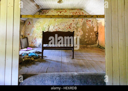 Bed lasciato dietro di sé in un abbandono cottage irlandese. Foto Stock