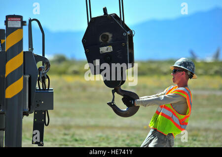 Stati Uniti Air Force Senior Airman Giosuè, 355Ingegnere Civile squadrone negozio orizzontale artigiano, guide un gancio da un all-terrain gru per la sua posizione di archiviazione durante la sostituzione di un aeromobile sistema di arresto a Davis-Monthan Air Force Base, Ariz., 28 marzo 2015. Il bak-12 è un aereo sistema di arresto che ha lo scopo di fermare un aeromobile assorbendo il suo slancio in un atterraggio di emergenza a causa di danno battaglia, perdita del sistema idraulico o di decollo abortito. Airman 1. Classe Chris Massey Foto Stock