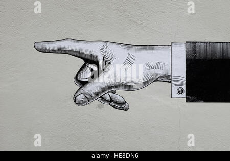 Illustrazione di puntamento a mano sulla parete edilizia Foto Stock