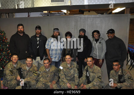 I membri del servizio hanno una foto scattata con la ex-New England Patriots offensivo affrontare la luce opaco, Washington cittadini primo baseman Adam LaRoche, 'Duck Dynasty' membro del cast Willie Robertson, ex corrispondente per la NBC di 'Voce' Alison Haislip, 'Duck Dynasty' membro del cast Jep Robertson, Grammy Award-winning cantante e cantautore Bridget Kelly e attore comico e Thomas "nipote Tommy' miglia, a Bagram Air Field, Afghanistan, Dic 10, 2013. I membri del servizio, dei civili e dei contraenti sono stati visitati dal presidente del Comune di capi di Stato Maggiore dell esercito, gen. Martin E. Dempsey, che ha guidato gli artisti interpreti o esecutori durante Foto Stock