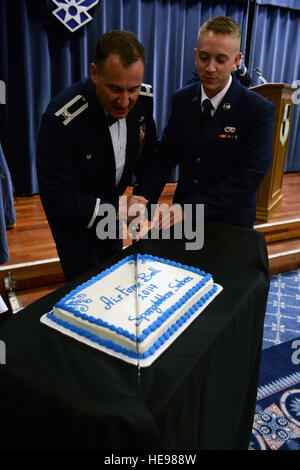 Stati Uniti Air Force Col. Pete Bilodeau, sinistra, 52nd Fighter Wing Commander, E DEGLI STATI UNITI Air Force Airman Basic Trevor Hume Wolanske, un operatore di un veicolo da 52 Disponibilità Logistica Squadron, tagliare la torta in commemorazione della Air Force il sessantasettesimo compleanno durante l'Air Force palla in Club Eifel a Spangdahlem Air Base, Germania, Sett. 13, 2014. Bilodeau e Hume Wolanske, come sia l'installazione più alti in classifica e junior-classifica aviatori, rispettivamente, tagliare la torta per Air Force tradizione. Airman 1. Classe Timoteo Kim Foto Stock