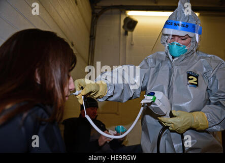 Il Mag. Terri Jennings, 48th Medical Group servizi di emergenza infermiere, esamina il personale Sgt. Amanda Beckwith, 48th MDG NCO in carica di servizi di ambulanza, durante una malattia piano di contenimento esercizio presso il Royal Air Force Lakenheath, Inghilterra, il 10 febbraio, 2015. Lo scopo dell'esercizio è stato quello di valutare la 48th Fighter Wing della capacità di rispondere e contenere una malattia contagiosa focolaio tra la popolazione di base garantendo la 48th FW è in avanti, Pronto, ora. Airman 1. Classe Erin R. Babis Foto Stock