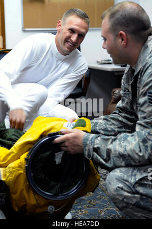 ASIA SUD-OVEST - Staff Sgt. Contrassegnare Reith aiuta Capt. Peter J. Gryn don la sua tuta specializzati prima di un volo il 4 ottobre, 2009. La sortie fu capitano Gryn la prima missione di combattimento. Entrambi gli avieri vengono distribuiti da Beale Air Force Base in California (Air Force foto/Staff Sgt. J.G. Buzanowski) Foto Stock