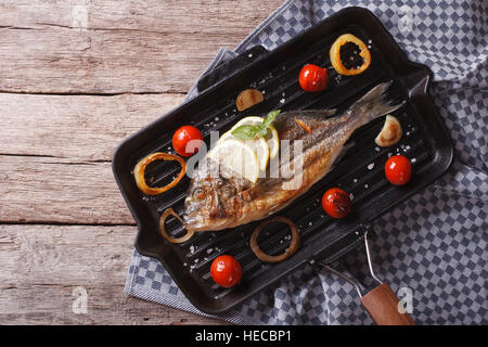 Dorado cucina di pesce sul nero padella per grigliare. vista orizzontale dal di sopra Foto Stock