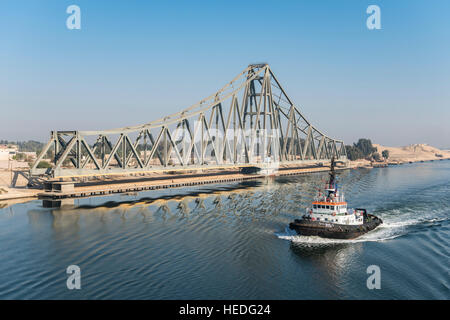 Rimorchiatore passa El Ferdan ponte ferroviario nel Canale di Suez vicino a Ismailia, Egitto Foto Stock