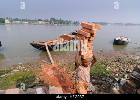 Khulna: porto di Fiume Bhairab, barca, uomini, carichi di bearer, Khulna Division, Bangladesh Foto Stock