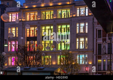 Il bagliore di finestre illuminate al negozio Uniqlo su Oxford St a Londra, Regno Unito Foto Stock