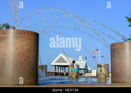 Bambina gioca nella fontana di acqua in un paesaggistico Riverfront Park lungo il fiume Cooper e Vendue Wharf in Charleston SC Foto Stock