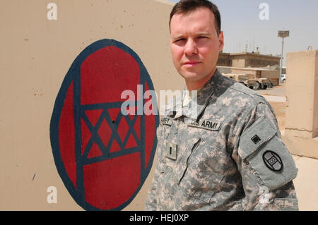 Primo Lt. Scott Sharkey di Colorado esercito nazionale della guardia militare 86Intelligence Company sta in piedi di fronte ad un dipinto di trentesimo Heavy Brigade Combat Team patch a inoltrare una base operativa Falcon Luglio 25. La patch, la versione di combattimento di cui può essere visto su Sharkey il manicotto sinistro, risale alla fondazione del trentesimo divisione di fanteria in 1917. Sharkey nonno, Allen è stato attaccato alla divisione nella II Guerra Mondiale e si è guadagnato una stella di bronzo con 'V' dispositivo per valor mentre con l'unità. Scott non era a conoscenza del fatto che suo nonno aveva servito con 'Old Hickory,' come l'allora la divisione e la corrente Foto Stock