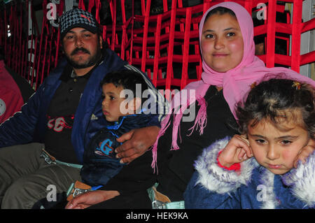 Il 9 marzo 2011 le famiglie egiziane a prepararsi per la lunga lotta da Djerba Zarzis Airport in Tunisia al Cairo, Egitto a bordo di una U.S. Air Force C-130J. Questi cittadini egiziani sono tra decine di migliaia di persone che sono fuggiti dal conflitto in Libia in Tunisia, in cui la crisi umanitaria è il dispiegamento. Questo C-130J, percorsa dalla 37th Airlift Squadron da Ramstein Air base, Germania, è parte di un contingente di aeromobile da la 37th e la 26th U.S. Marine Expeditionary Unit che stanno ricevendo gli sfollati home. Poiché le operazioni ha cominciato il 4 marzo, più di 750 passeggeri sono stati spostati al Cairo. Il airlif Foto Stock