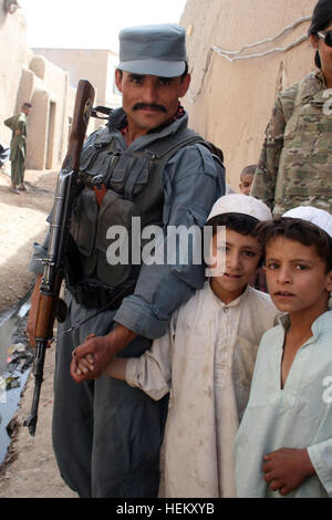 La città di Kandahar, Afghanistan (sett. 30) - Un afghano poliziotto in uniforme da polizia stazione secondaria 16 tiene le mani con un giovane ragazzo afghano dalla comunità circostante sett. 30. AUP, insieme con le loro forze di coalizione da partner di 58th Polizia Militare azienda attaccata al 2° Brigata Team di combattimento, 4a divisione di fanteria, erano patroling il quartiere di raggiungere le persone al fine di affrontare i loro problemi e condividere con loro le informazioni sul governo della Repubblica islamica dell'Afghanistan e le buone cose che stanno facendo. (U.S. Esercito foto di Spc. Aprile York, seconda BCT, quarto Inf. Div., P Foto Stock