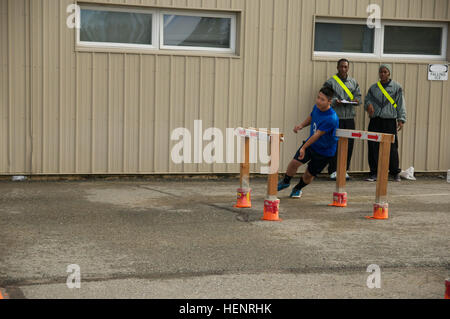Paracadutisti da 725th brigata battaglione di supporto, quarta brigata di fanteria combattere Team (airborne), XXV divisione di fanteria grado a cadet in Run-Dodge-e-Jump evento come parte del 2014 Raider Cup concorrenza a Camp Carroll su base comune Elmendorf-Richardson, Alaska sett. 6, 2014. Il Run-Dodge-e-Jump è un test di agilità e coordinamento nella realizzazione di rapidi cambiamenti di direzione durante la corsa e come una misura della capacità di salto. (U.S. Esercito foto di Sgt. Brian Ragin/RILASCIATO) Paracadutisti da 725th brigata battaglione di supporto, quarta brigata di fanteria combattere Team (airborne), XXV divisione di fanteria gra Foto Stock