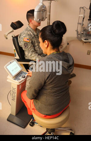 Durante la fase di pre-screening, di processo SPC. Daniel Bocanegra, (sinistra), un 26-anno-vecchio medic assegnato alla società B, William Beaumont Army Medical Center, Fort Bliss, Texas, riceve un esame oculistico da Warfighter rifrazione chirurgia oculare centro supervisore clinico Frances Sanchez, nativo di Silver City, N.M., Dic 10. Bocanegra, nativo del Corpus Christi, avrà cheratectomia fotorefrattiva chirurgia per correggere la sua scarsa visione. (U.S. Esercito Foto di Sgt. James Avery, XVI Mobile degli affari pubblici distacco) il senno di poi è 20-20, Warfighter rifrazione chirurgia oculare centro ha una visione del futuro 141210-A-FJ97 Foto Stock