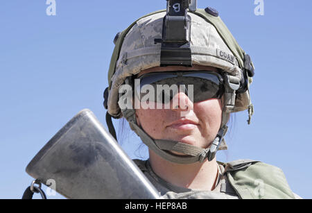 Stati Uniti Soldato dell'esercito PFC. Taylor Coan, dal 3° Battaglione, campo xiii reggimento di artiglieria, fissata per il 2° Brigata Team di combattimento, 1° Divisione di Fanteria, entra in pausa per un ritratto proteggendo al tempo stesso la sua area di operazioni durante un'azione decisiva la rotazione 15-06 presso il National Training Center, Fort Irwin, California, 25 marzo 2015. Coan è un multiplo del lancio del razzo le operazioni di sistema/fire direzione specialista di Folsom, California (U.S. Esercito foto di Spc. Ashley marmo/RILASCIATO) 2° Brigata Team di combattimento, 1° Divisione di Fanteria presso il Centro Nazionale di Allenamento 150325-A-AP678-034 Foto Stock