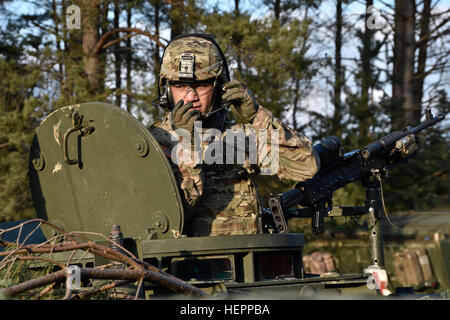 Un trooper assegnato alla truppa mietitore, quarto squadrone, 2° reggimento di cavalleria, controlli il suo auricolare mentre equitazione di artigliare la posizione di un M1134 Anti-Tank missile guidato il veicolo prima di uscire per la gamma per lo squadrone live-fire esercitare all'Grafenwoehr Area Formazione, situato vicino alla caserma di Rose, Germania, 15 marzo 2016. Lo scopo del live-fire esercizio era di contribuire a convalidare il reggimento la missione di piattaforme di comando mentre si conduce una capstone-evento di formazione che comprende una fase di transizione dal Movimento per le capacità di manovra. (U.S. Esercito foto di Sgt. William A. Tanner) Reaper truppa, Foto Stock