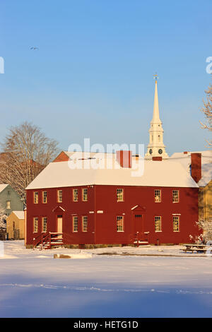 Il campanile della chiesa del Nord aumenta al di sopra di una casa a Strawbery Banke Museum di Portsmouth, New Hampshire. L'inverno. Foto Stock