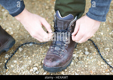 Vista ritagliata della legatura uomo laccio su escursioni boot Foto Stock