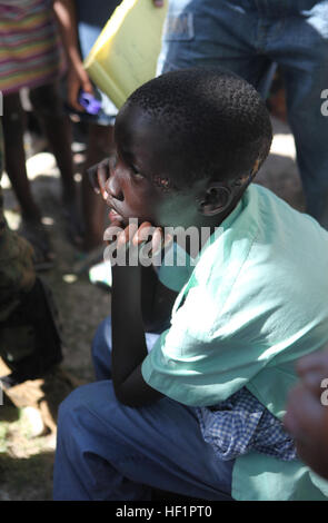 Un ragazzo haitiana attende di essere visto da corpsmen dal battaglione Team Leader, 3° Battaglione, 2° Reggimento Marini, 22 Marine Expeditionary Unit, durante una missione medica in Dano, Haiti, gen. 28. Tutta la missione, corpsmen trattato più di 60 pazienti con ferite che vanno da infezioni gravi per il mal di testa. Xxii MEU Corpsmen portare sorrisi a Haiti DVIDS245448 Foto Stock