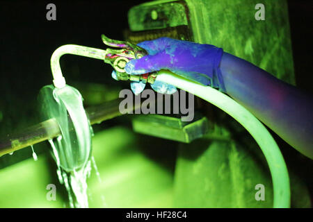 Stati Uniti Air Force Airman 1. Classe Amy Ferry versa acqua su un pezzo di metallo di formazione durante una particella magnetica ispezione del giugno 18, 2014 a Atlantic City Air National Guard Base, N.J. Una particella magnetica ispezione rivela qualsiasi superficie e sottosuolo difetti del metallo magnetico voci. Il traghetto è un controllo non distruttivo specialista assegnato al New Jersey Air National Guard 177th della manutenzione aeromobili squadrone. (U.S. Air National Guard foto di Tech. Sgt. Matt Hecht/RILASCIATO) sotto la luce 140618-Z-NI803-027 Foto Stock