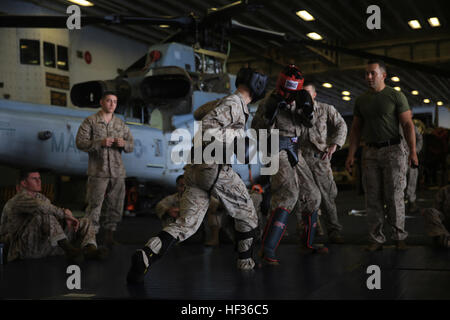 Marines con Battaglione Team di atterraggio 3° Battaglione, 6° Reggimento Marini, 24 Marine Expeditionary Unit, condurre un pieno contatto sessione sparring come parte della cintura verde durante la certificazione Marine Corps Arti Marziali training del programma a bordo dell'assalto anfibio nave USS Iwo Jima (LHD 7), 10 aprile 2015. Il ventiquattresimo MEU è imbarcata su Iwo Jima anfibio gruppo pronto e distribuito per mantenere la sicurezza regionale negli Stati Uniti Quinta Flotta area di operazioni. (U.S. Marine Corps photo by Lance Cpl. Dani A. Zunun/RILASCIATO) Marines americani continuano la lotta in mare 150410-M-WA276-008 Foto Stock