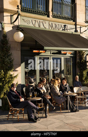 Danimarca, Copenaghen, Østergarde, Café Norden visitatori seduti ai tavoli esterni in inverno il sole Foto Stock