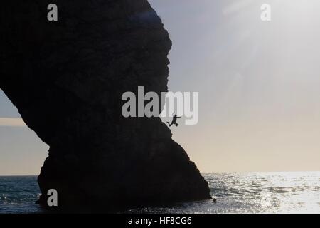 Porta di Durdle, Dorset, Regno Unito. Il 28 dicembre 2016. Un nuotatore salta fuori porta di Durdle come la costa del Dorset si crogiola al sole e unseasonably tempo caldo. Credito: Tom Corban/Alamy Live News Foto Stock