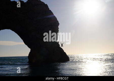 Porta di Durdle, Dorset, Regno Unito. Il 28 dicembre 2016. Un nuotatore salta fuori porta di Durdle come la costa del Dorset si crogiola al sole e unseasonably tempo caldo. Credito: Tom Corban/Alamy Live News Foto Stock