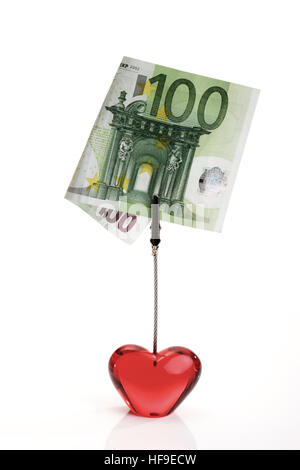 Vetro rosso cuore tenendo un 100-Euro bill: l amore per la vendita Foto Stock