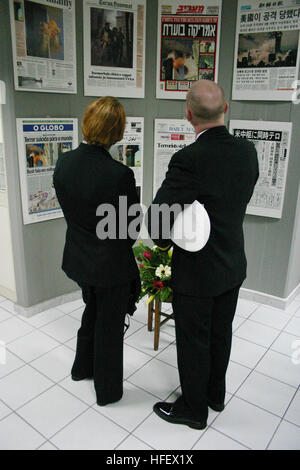 040325-N-5821W-003 Serradifalco, Sicilia (Mar. 25, 2004) Ð Aviazione Administrationman manutenzione 2a classe Susan Schmitt, sinistro e il Tenente j.g. Chris Newell guardare oltre le copie delle prime pagine dei giornali con gli eventi che si verificano sul Sett. 11, 2001 presso una scuola situata a Serradifalco, Sicilia. La città di Serradifalco ha invitato i membri della Naval Air Station (NAS) Sigonella per una cerimonia di inaugurazione di un monumento commemorativo degli eventi di settembre 11, 2001, e quelli di nov. 12, 2003, quando 12 Carabinieri, cinque esercito italiano e due civili italiani sono stati uccisi a Nassiriya in Iraq. Foto Stock