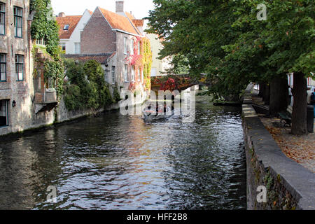 I canali di Bruges offrono fascino e un unico vantage per visualizzare la città e il tour di tela barche il loro modo attraverso le acque. Foto Stock