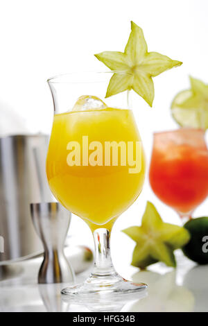 Due cocktail: orange - e Strawberry Daiquiri guarnita con starfruit Foto Stock