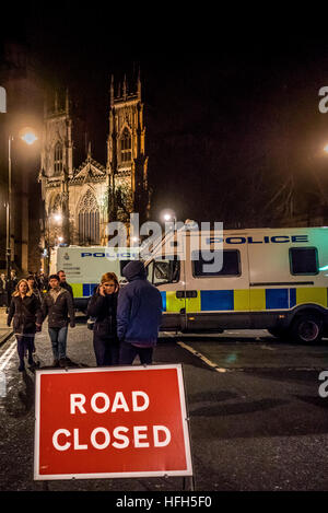 York, Regno Unito. Il 31 dicembre, 2016. Capodanno festaioli si radunano a York Minster per celebrare l'inizio del 2017. Sulla scia del recente terrore carrello attacco a Berlino, Polizia furgoni usati per bloccare l'accesso al veicolo al Minster, e un contingente armato di ufficiali hanno partecipato all'evento. Foto Fotografia Bailey-Cooper/Alamy Live News Foto Stock