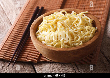 Asian spaghetti ramen in ciotola di legno vicino sul tavolo orizzontale. Foto Stock