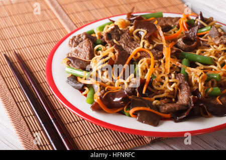 Lo mein con carne di manzo, muer e verdure close-up su una piastra orizzontale. Foto Stock